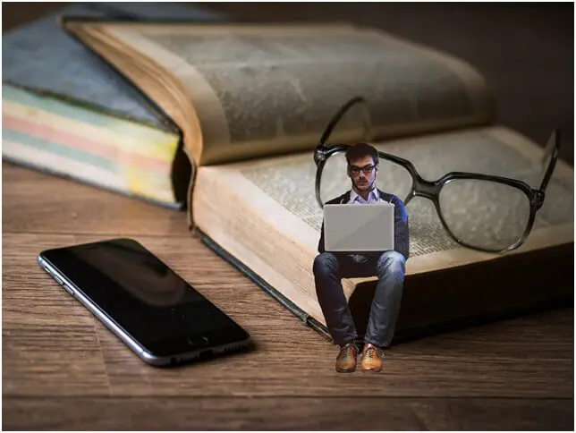 Student Sitting on Book and Table