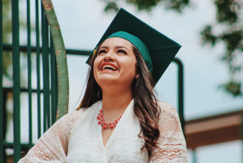 Girl Laughing wearing Graduation Cap