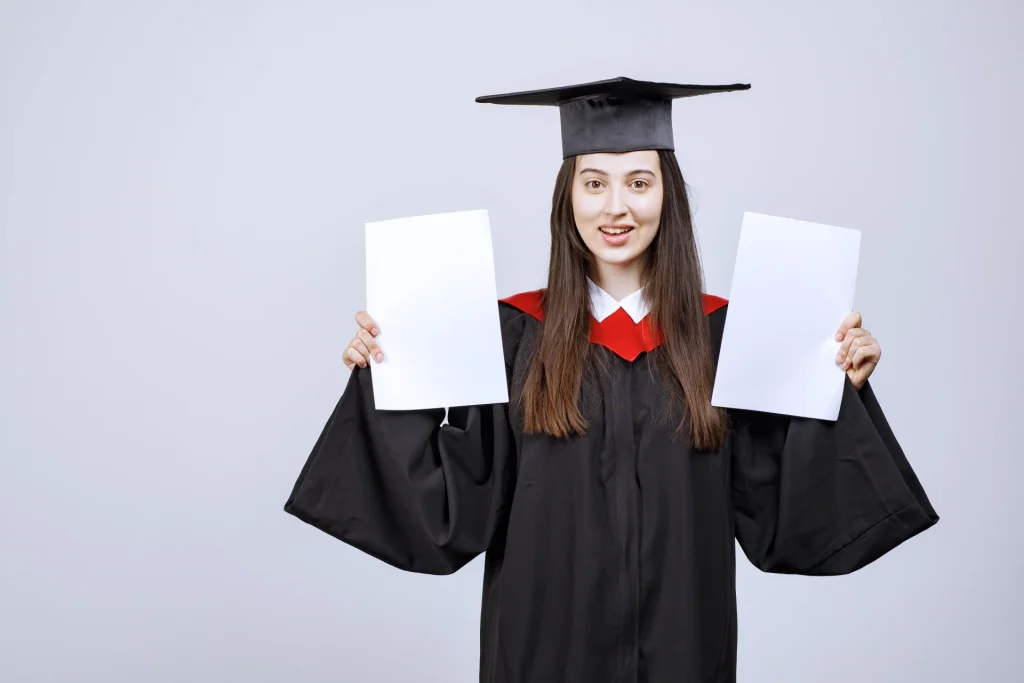 Student proudly showcasing dual MBA degrees