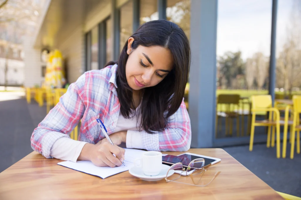 MBA applicant crafting their IMD essay.